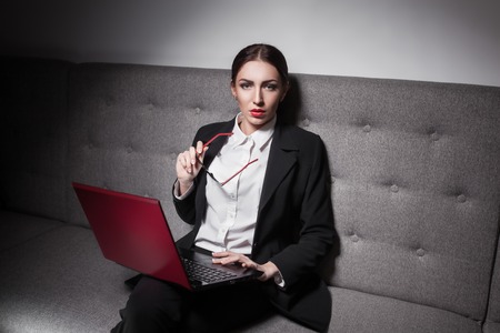 businesswoman dressed in suit and with laptop;の写真素材