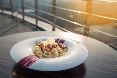 italian carbonara pasta with meat and cheese; traditional meal of italy with parmesan;の写真素材