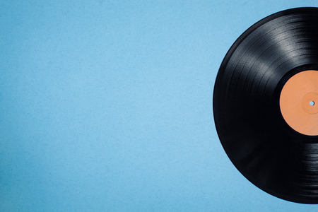 vinyl musical disc on blue background; vintage audiophile and musiclover postcard;の写真素材