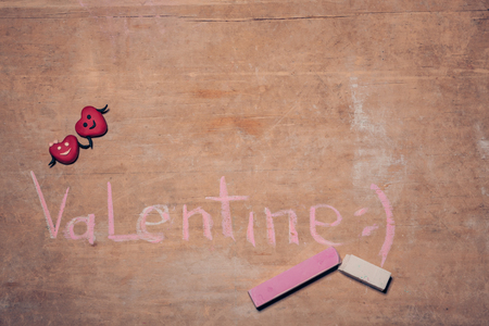 celebrative postcard painted with chalk; red valentines day hearts on wooden background;の写真素材