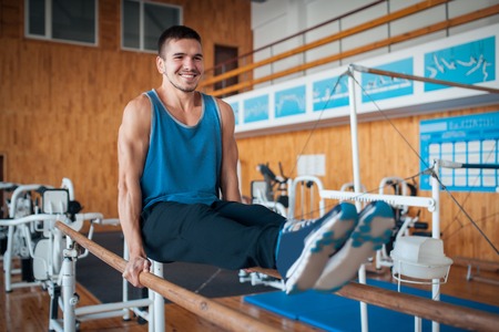 sportsman has workout with gymnastics bar;の写真素材