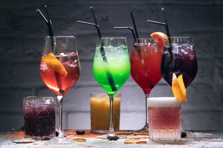 colored funny drinks on brick background and with decorの写真素材