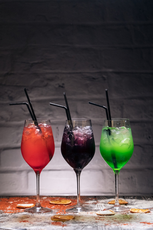 colored funny drinks on brick background and with decorの写真素材