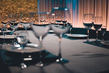 table setting with shiny wineglasses in restaurantの写真素材