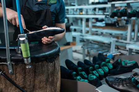male work with footwear assembling machine on fabric