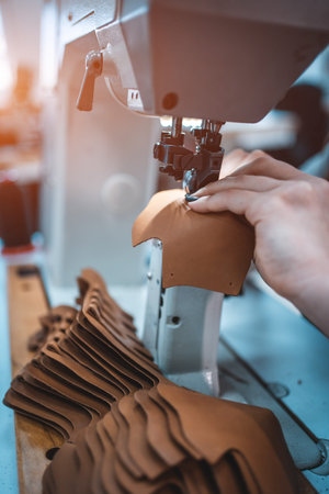 female working with sew machine on footwear fabric