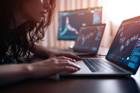 brunette female trade forex or cryptocurrency at homeの写真素材