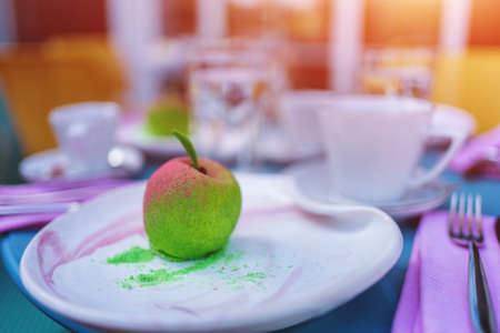 colored baked mousse dessert that looks like appleの写真素材