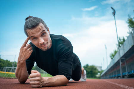 young athlete push up and plank at stadium outdoorの写真素材