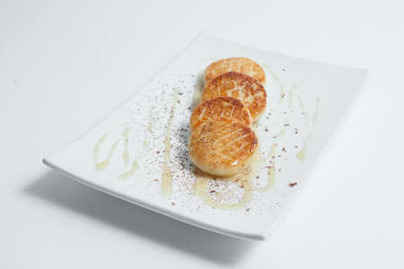 traditional russian cheesecakes with sour cream from cottage cheese isolatedの写真素材