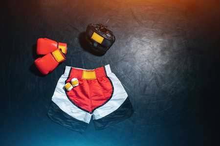 top view of boxing gloves, shorts, helmet and bandage tape on black backgroundの写真素材