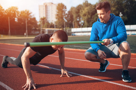 sport man has workout or exercising outdoor with personal fitness trainer