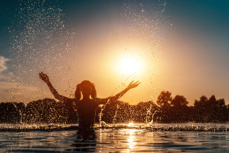 happy female in red bikini splashing or play in water and have fun at sunset