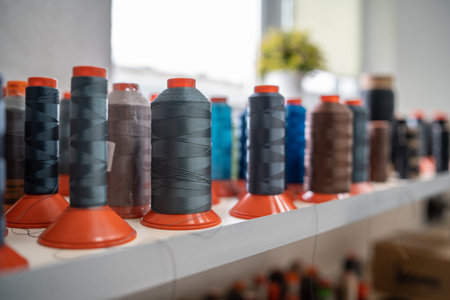 closeup of color sewing thread set at textile or clothing factory or manufacture