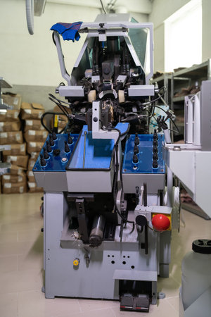 professional pulling over lasting machine at shoe factory