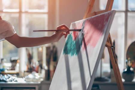 woman artist paint with brushes and oil dyeの写真素材