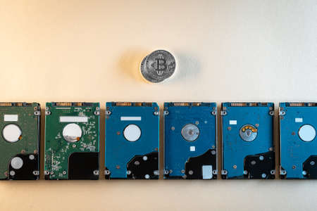 top view of bitcoin cryptocurrency coin with hard disk drive hdd, flat layの写真素材
