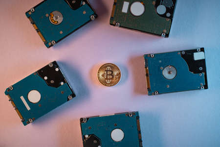 top view of bitcoin cryptocurrency coin with hard disk drive hdd, flat layの写真素材