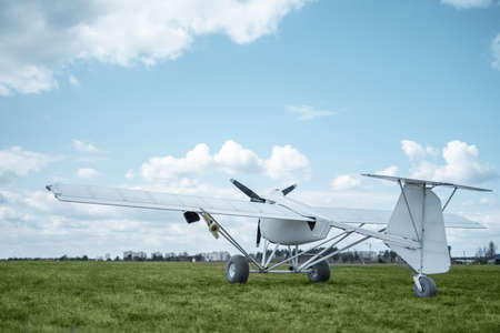remote controlled agriculture spaying air plane in field at sunset, no peopleの写真素材