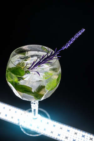 cocktail hugo or mojito with mint, lime and ice in wineglass on black backgroundの写真素材