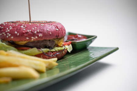 closeup of fresh tasty red burger wit french fries and sauce on white backgroundの写真素材