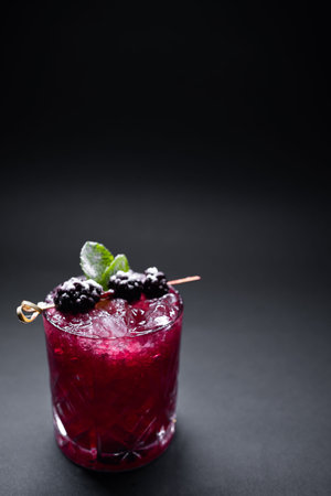 closeup of alcohol blueberry special cocktail with blackberry in wineglassの写真素材