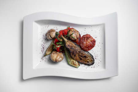 top view of grilled vegetables and champignon on white plate on white backgroundの写真素材