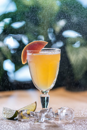 refreshing lemonade drink with grapefruit and ice in glass under water sprayingの写真素材