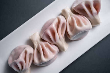 georgian dumplings with meat or sweet strawberry khinkali on black backgroundの写真素材