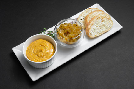 close up of goose liver pate with apple chutneys and bread on black backgroundの写真素材