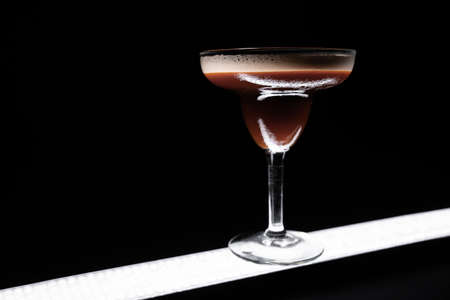 luxury espresso martini cocktail drink in elegant glass on black backgroundの写真素材