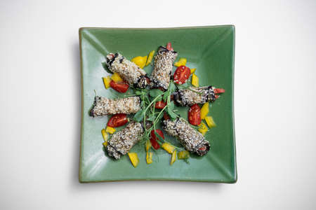 top view of eggplant rolls with cheese or vegetable on plate on white backgroundの写真素材
