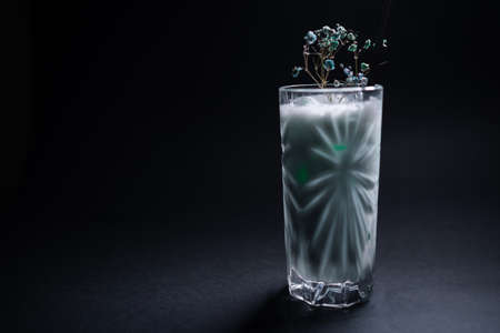 milk drink or cocktail blue hawaii decorated in glass on black backgroundの写真素材