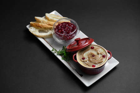 close up of goose meat liver pate with cranberry and bread on black backgroundの写真素材