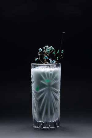 milk drink or cocktail blue hawaii decorated in glass on black backgroundの写真素材
