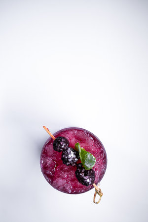 top view of alcohol blueberry special cocktail with blackberry in wineglassの写真素材