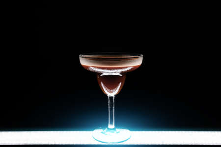 luxury espresso martini cocktail drink in elegant glass on black backgroundの写真素材