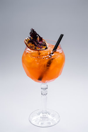close up of orange lychee cocktail in glass on white backgroundの写真素材