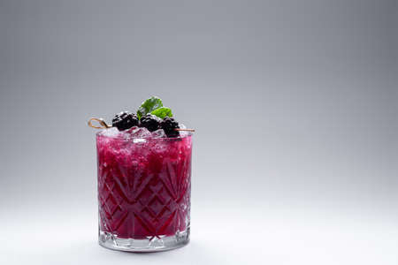 closeup of alcohol blueberry special cocktail with blackberry in wineglassの写真素材