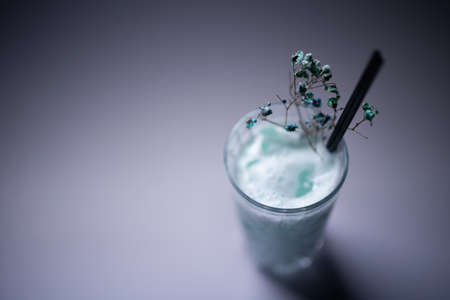 milk drink or cocktail blue hawaii decorated in glass on grey backgroundの写真素材