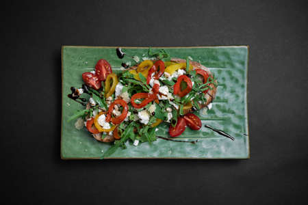 top view of bruschetta or toast bread with arugula, tomatoes, cheese and pepperの写真素材