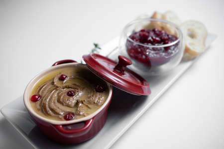 close up of goose meat liver pate with cranberry and bread on white backgroundの写真素材