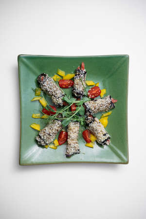 top view of eggplant rolls with cheese or vegetable on plate on white backgroundの写真素材