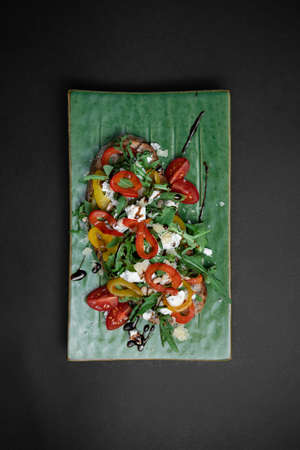 top view of bruschetta or toast bread with arugula, tomatoes, cheese and pepperの写真素材