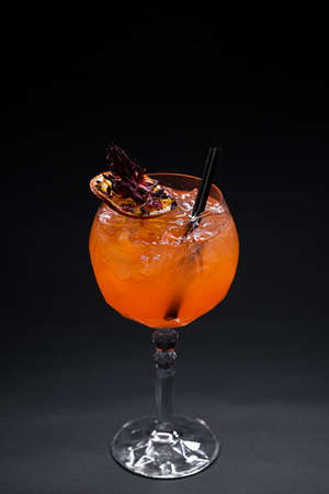 close up of orange lychee cocktail in glass on black backgroundの写真素材
