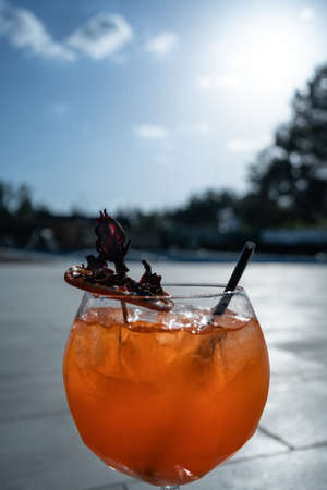 close up of fresh orange lychee cocktail with ice in glass outdoorの写真素材