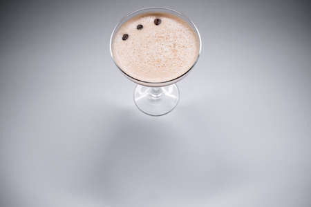 luxury espresso martini cocktail drink in elegant glass on grey backgroundの写真素材