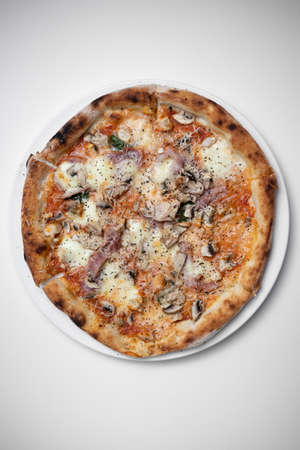 top view of italian pizza with ham, mushrooms and cheese on white backgroundの写真素材