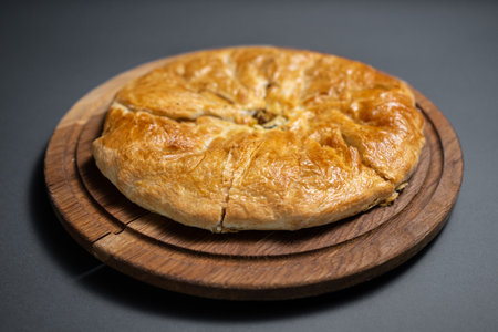 georgian khachapuri with mushrooms and potato or cheese pie on wooden boardの写真素材