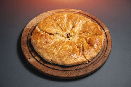 georgian khachapuri with mushrooms and potato or cheese pie on wooden boardの写真素材